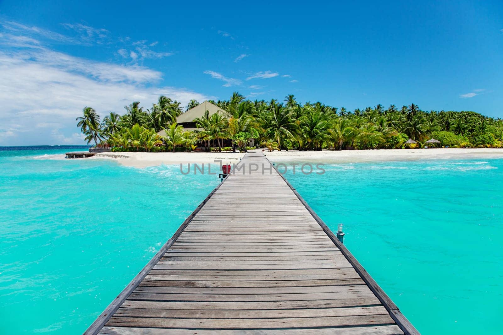 Idyllic landscape with wood path among blue water