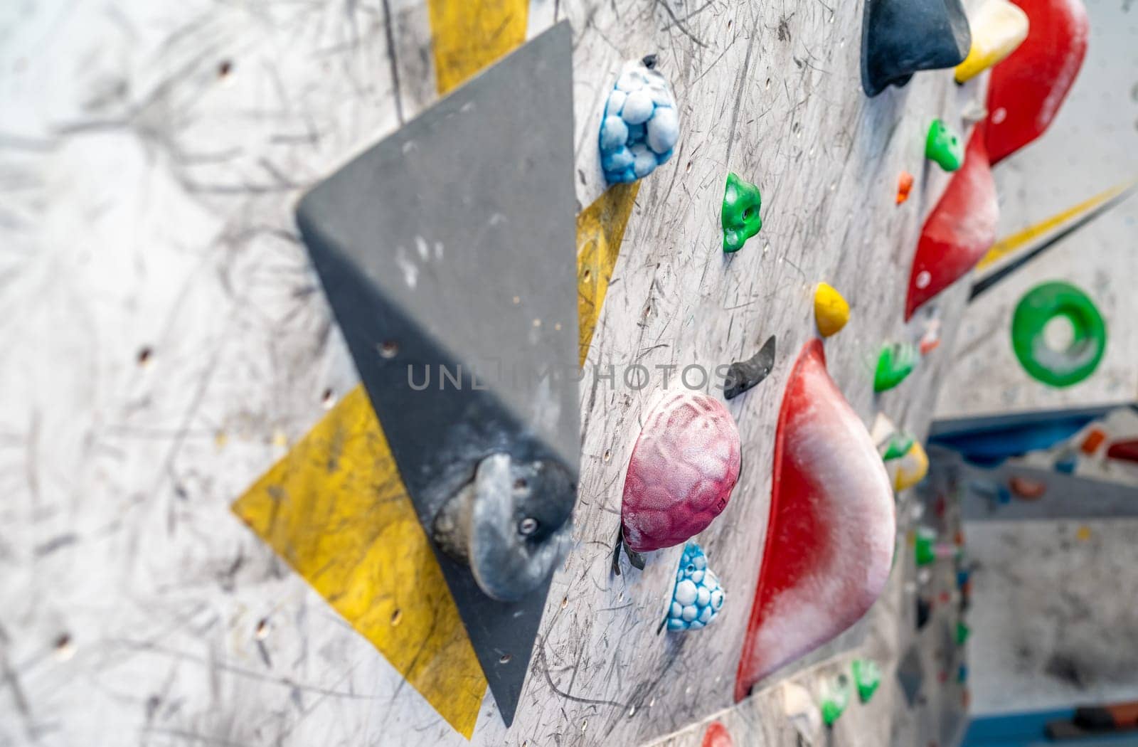 artificial climbing wall with colorful holds. High quality photo