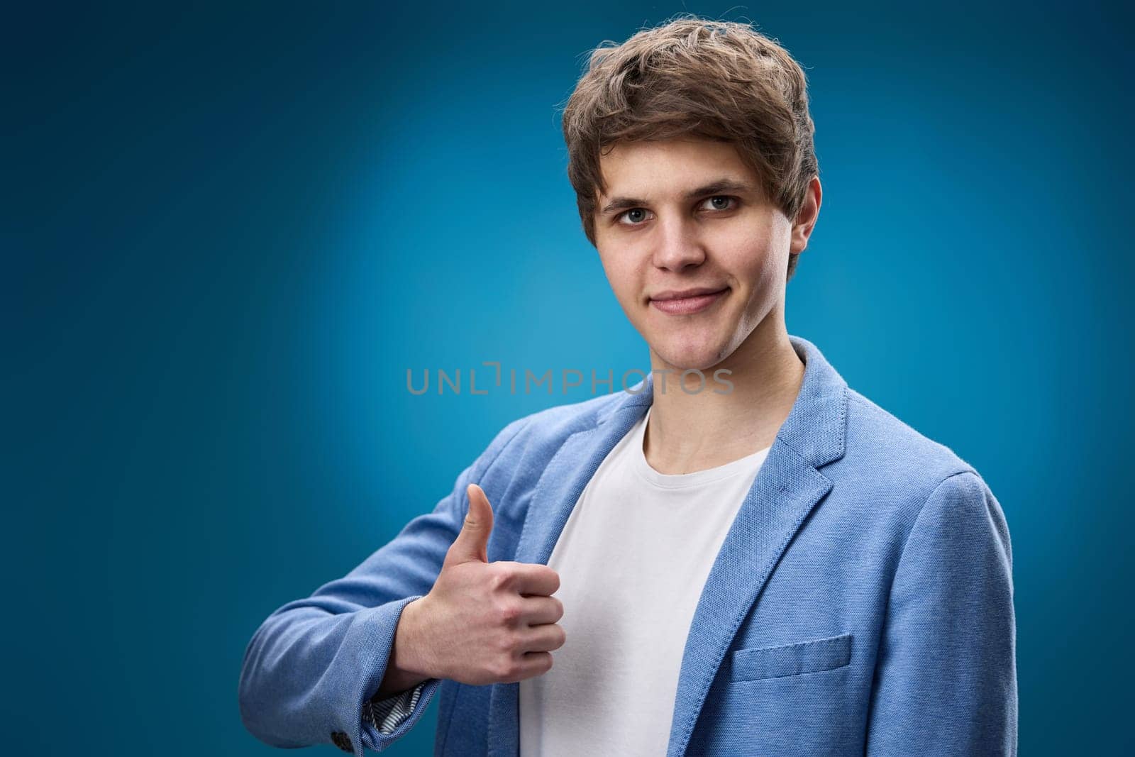 happy young man in jacket showing Ok gesture by erstudio