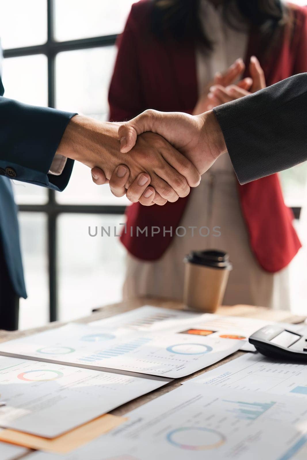 Business people shaking hands in the office. Finishing successful meeting. celebration partnership and business deal concept by nateemee