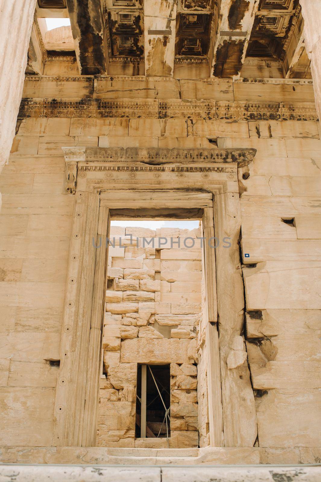 Ancient Greek ruins of Propylaea on a top of Acropolis hill in Athens. Acropolis - main tourist attraction of Athens. Greece