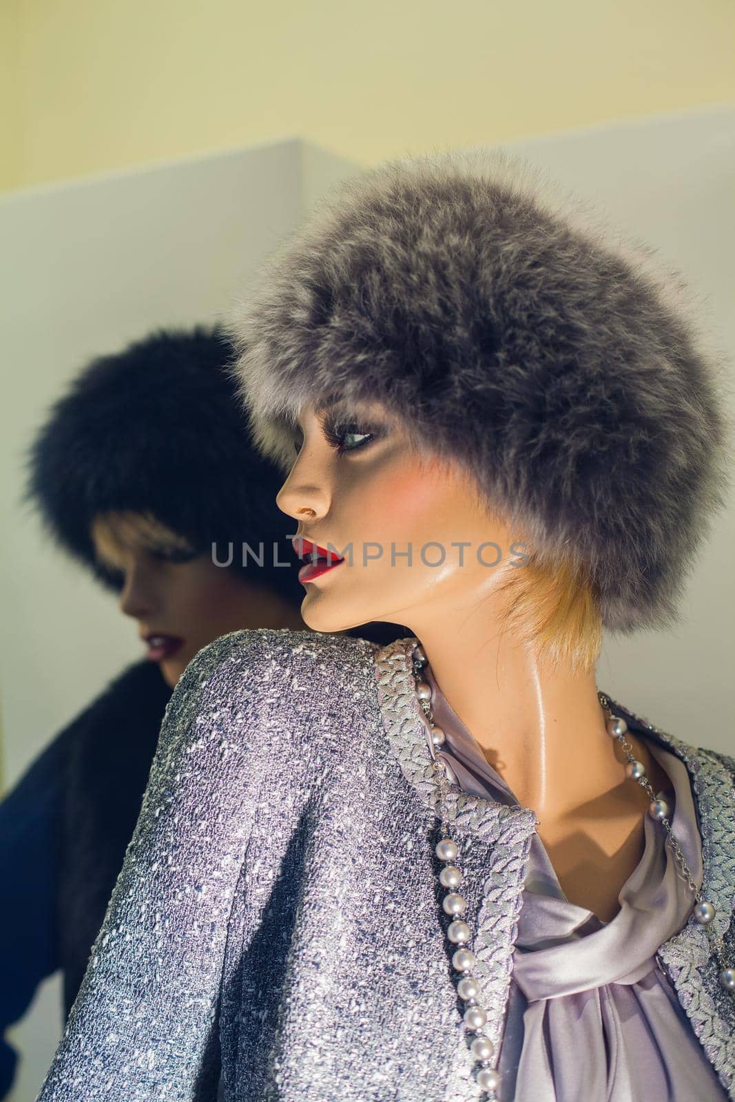 Female mannequin with fur hat in the boutique