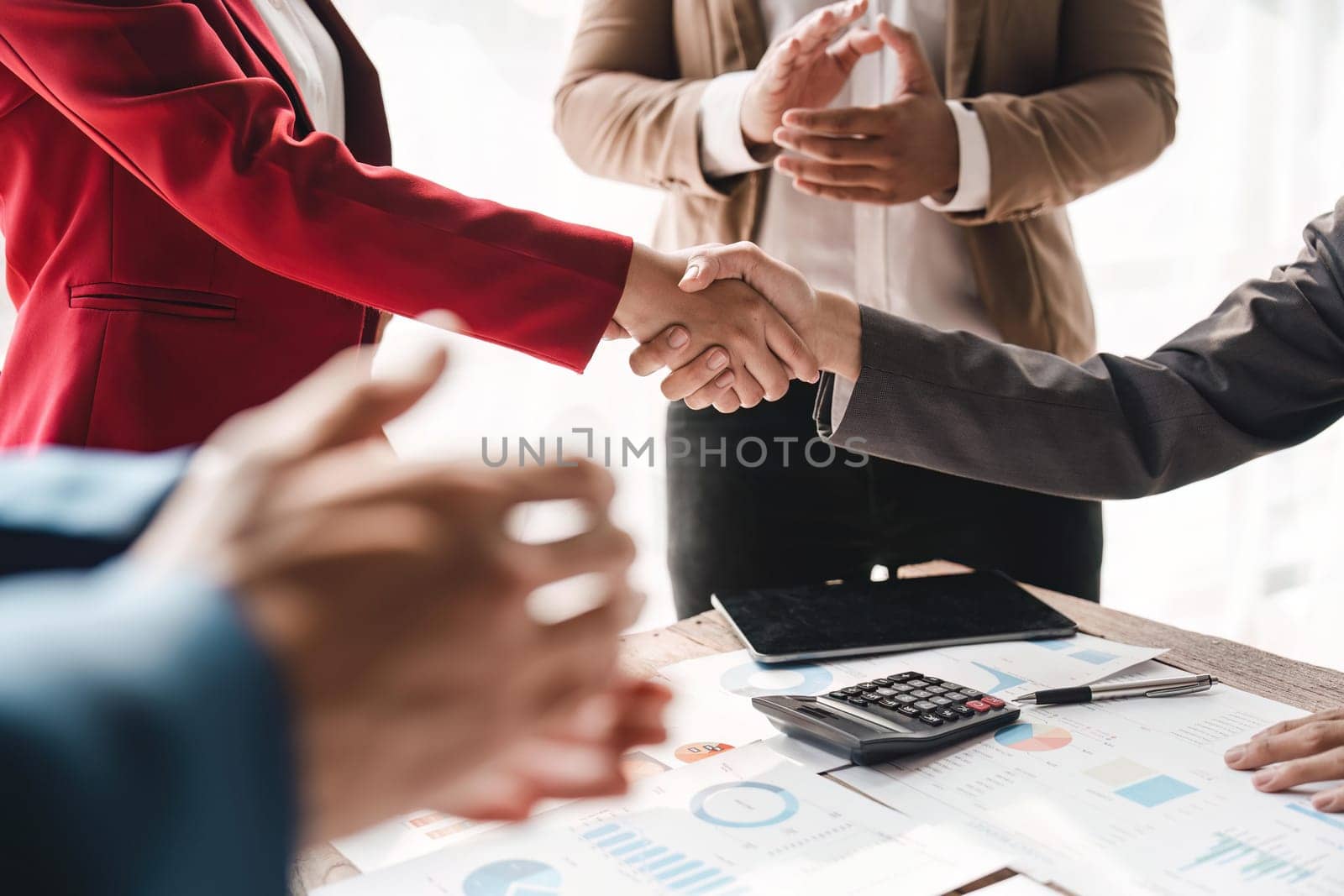 Business people shaking hands in the office. Finishing successful meeting. celebration partnership and business deal concept by nateemee