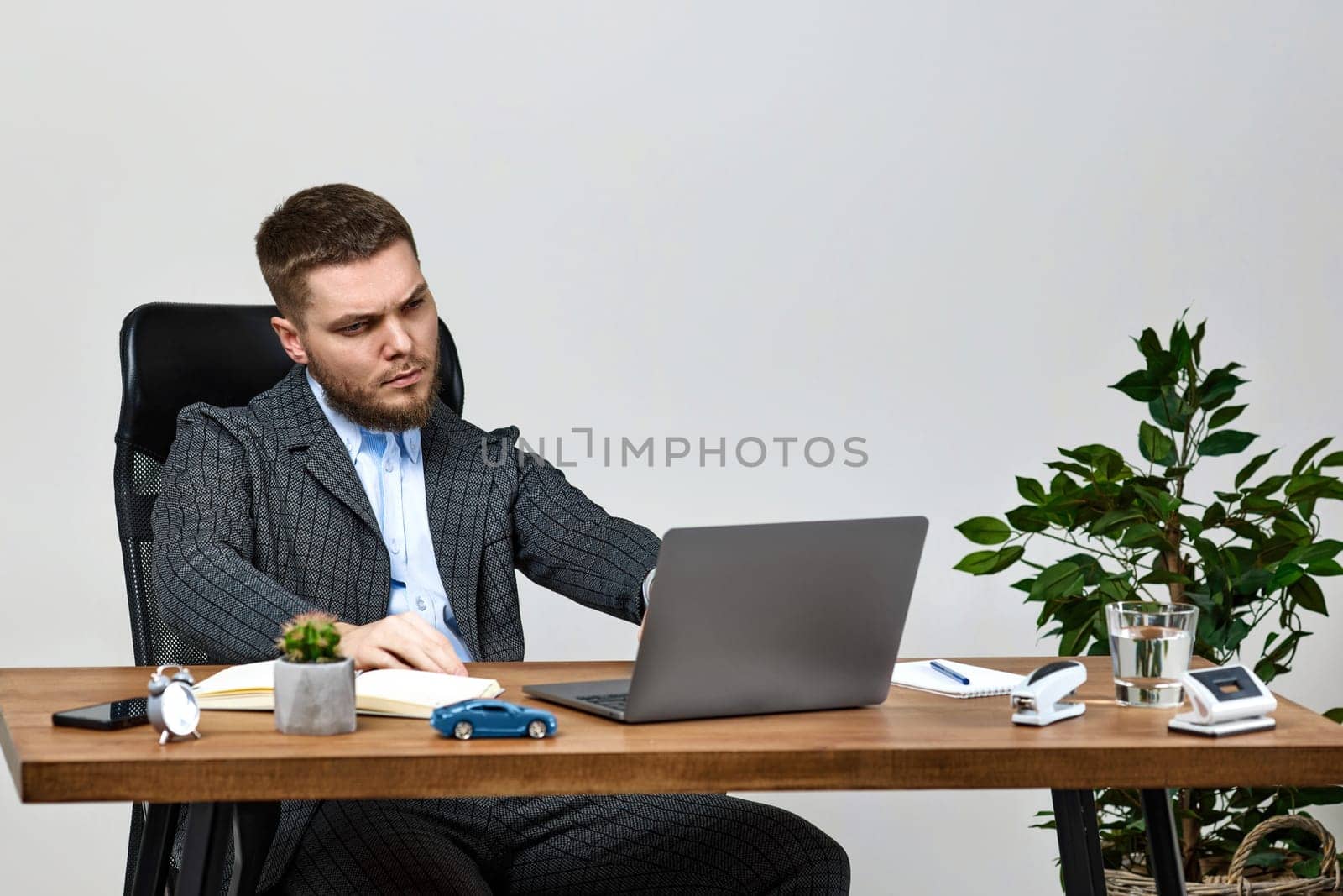 young man using laptop computer for online work at table