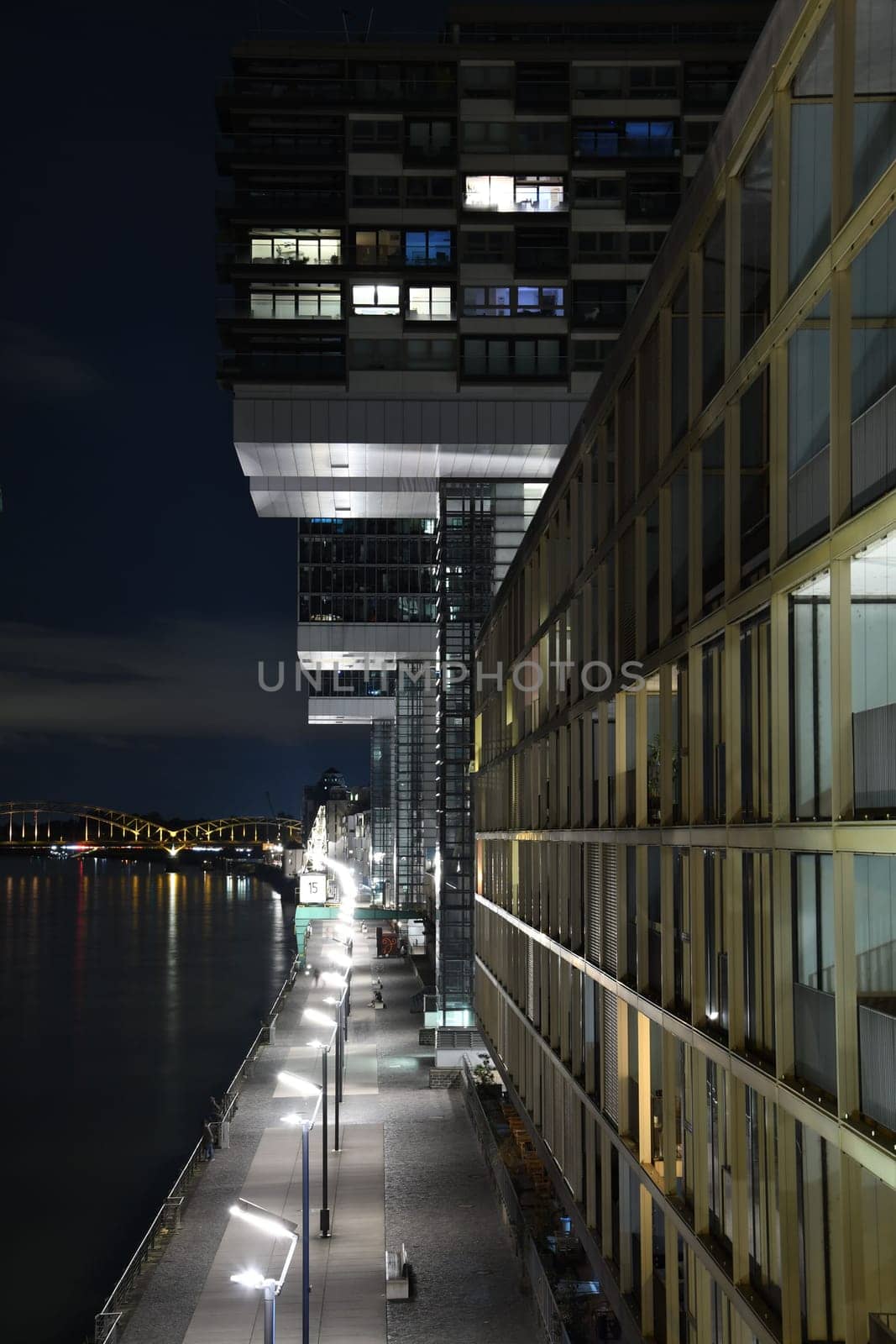 View of the illuminated promenade from crane house balcony in Germany at night