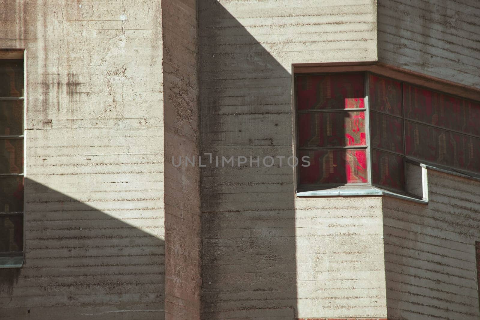 Stained glass window in concrete facade on a church that looks like a bunker in Cologne, Germany