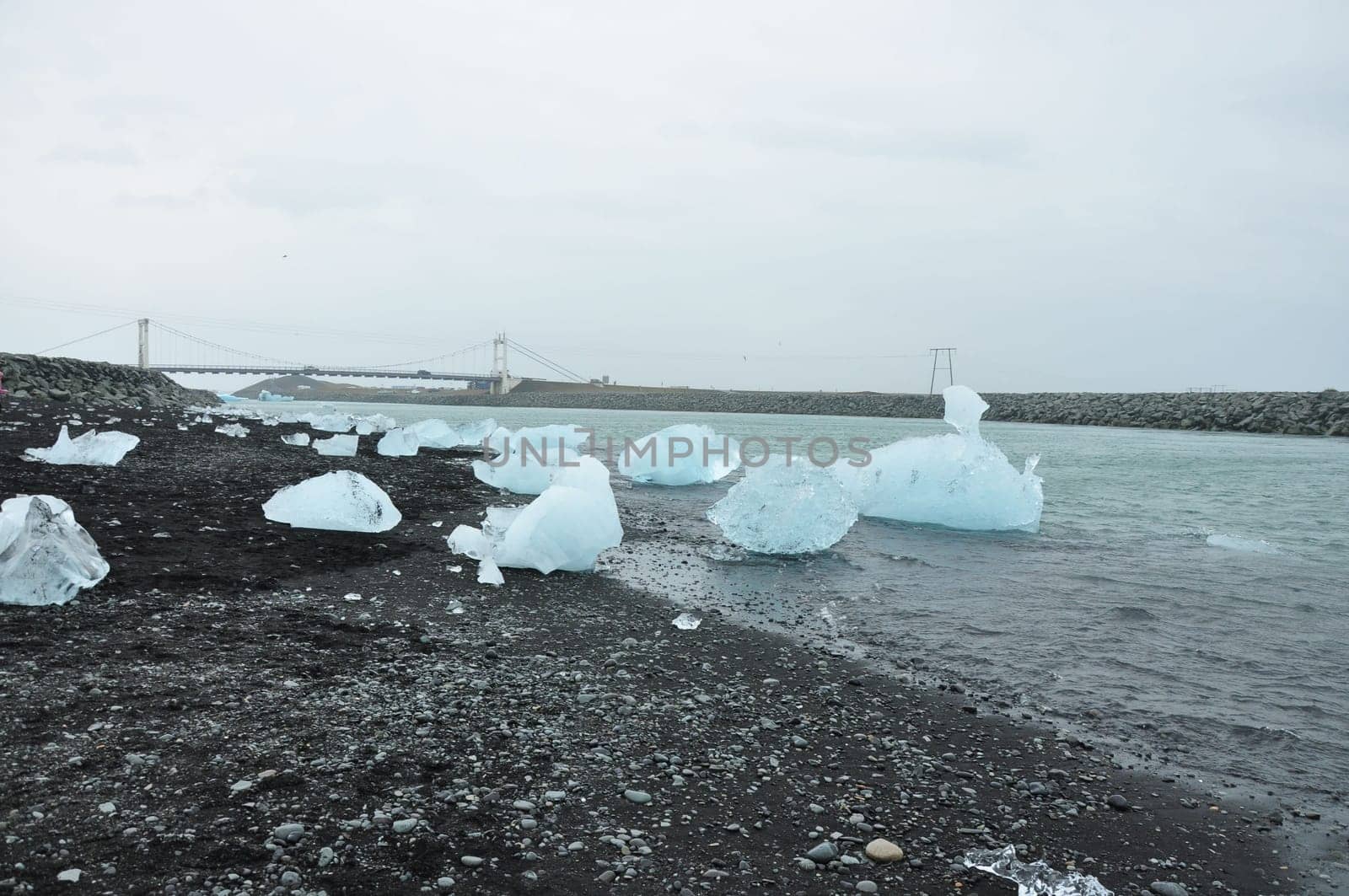 Crystal clear ice chunks at Diamond beach with black sand in Fellsfjara, Jokulsarlon on Iceland