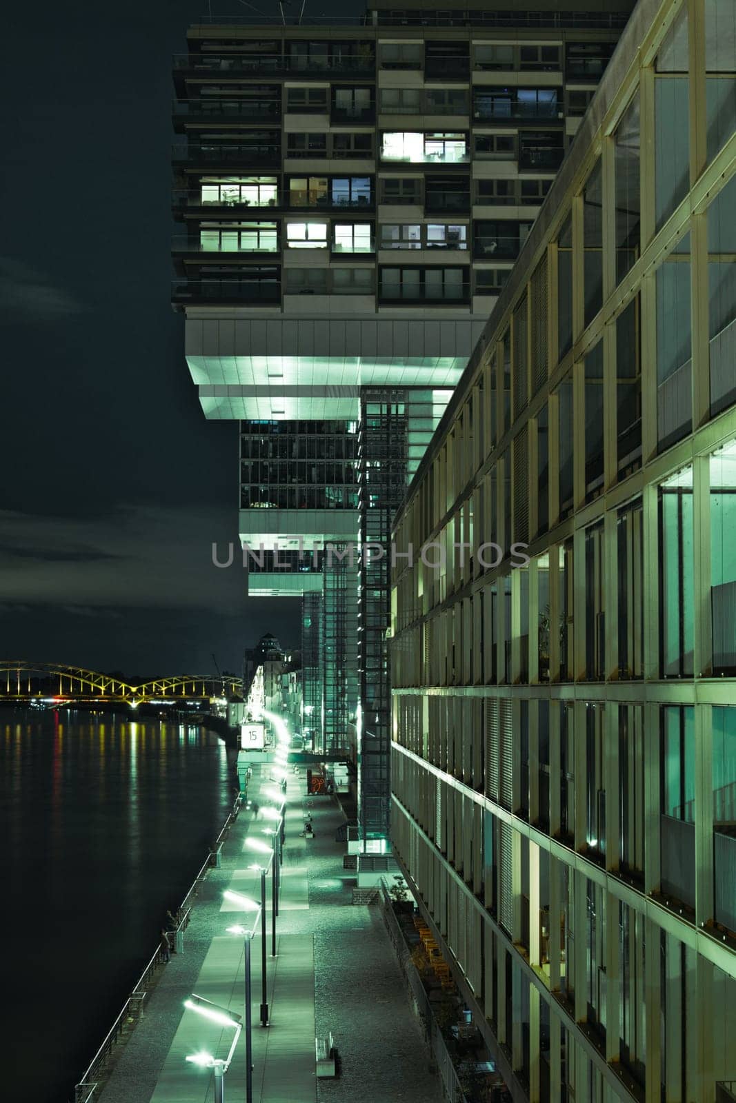 Rhine bank promenade along the crane houses at night in Cologne, Germany