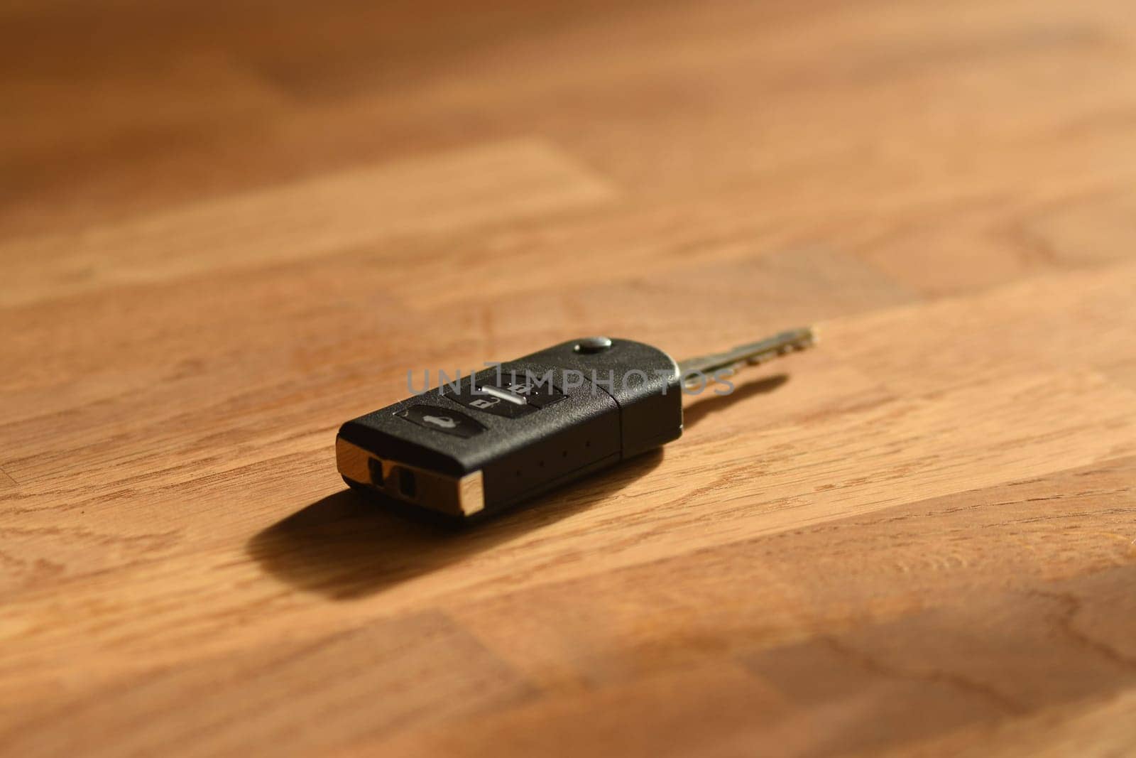 Closeup shot of car keys on a wooden table
