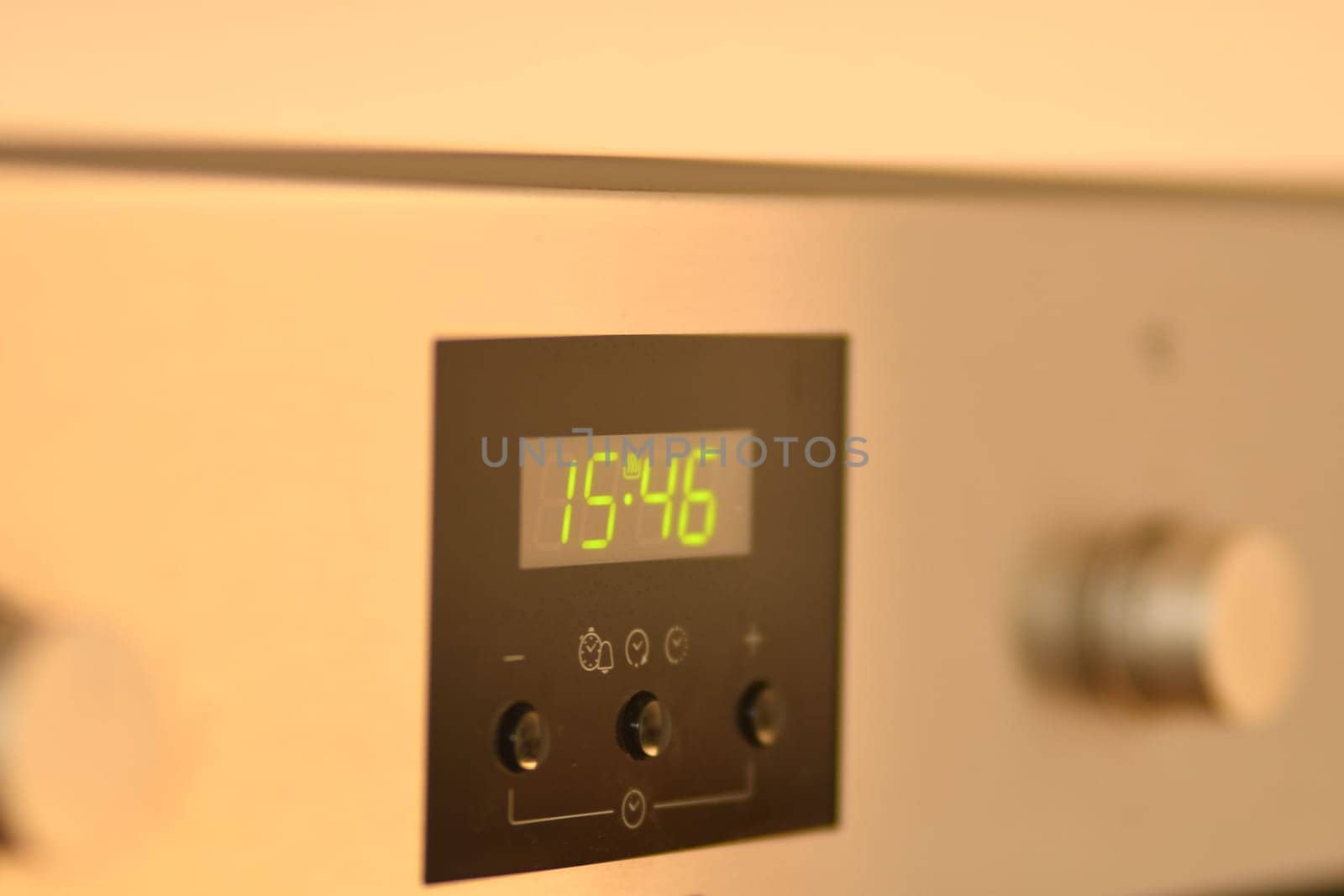 Green LED digital clock on an oven in Germany
