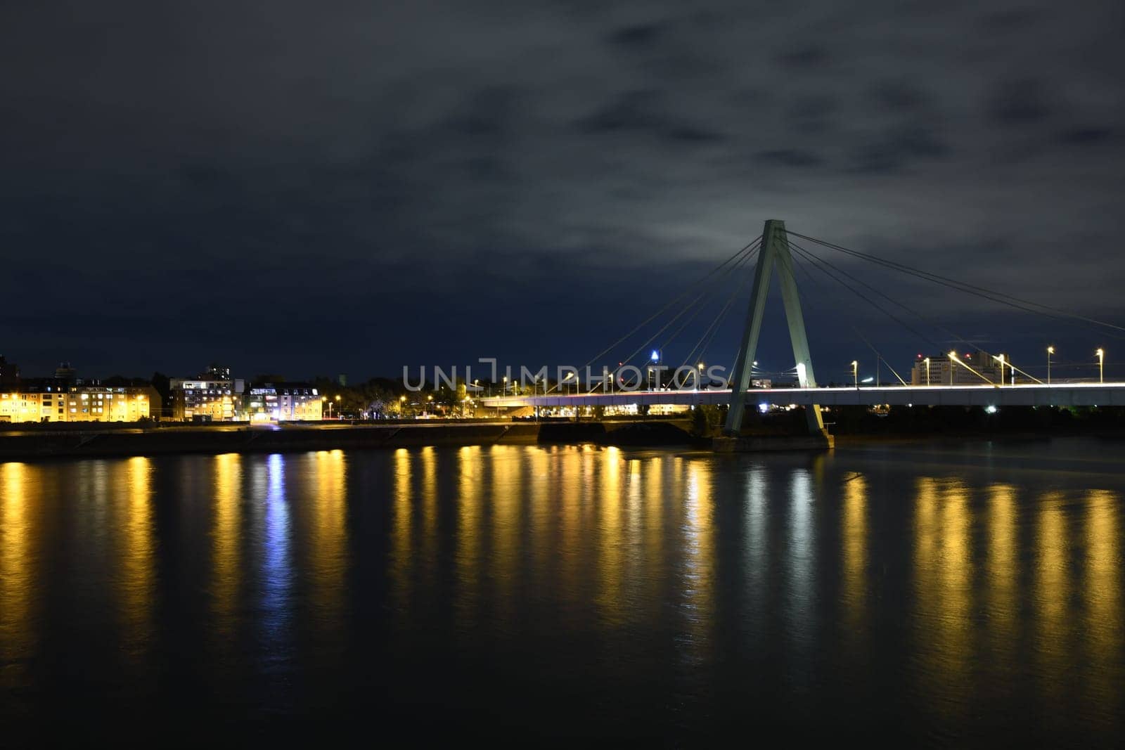 Severinsbrucke and the Rhine at night in Cologne, Germany