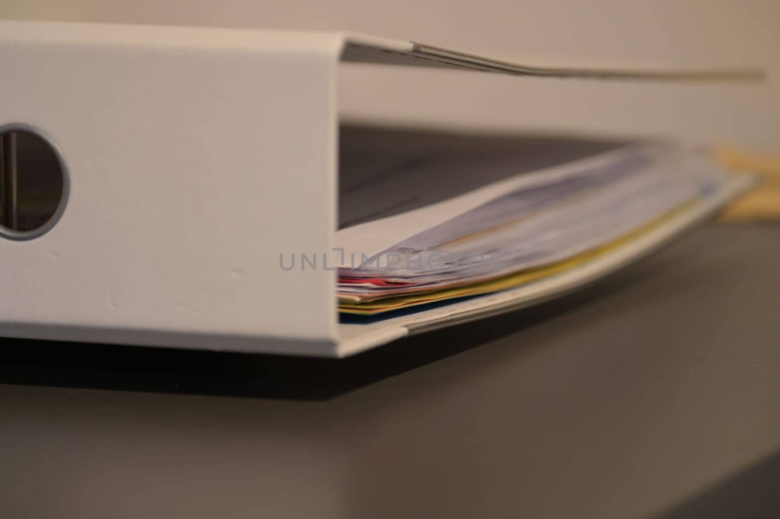 Documents and papers in a white file folder