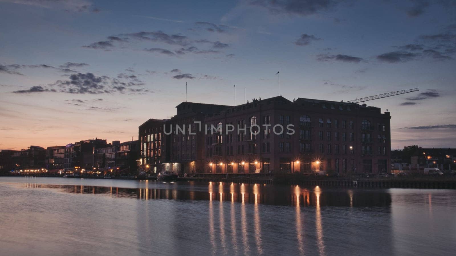 Old brick building illuminated at sunset in the harbor of Munster, Germany