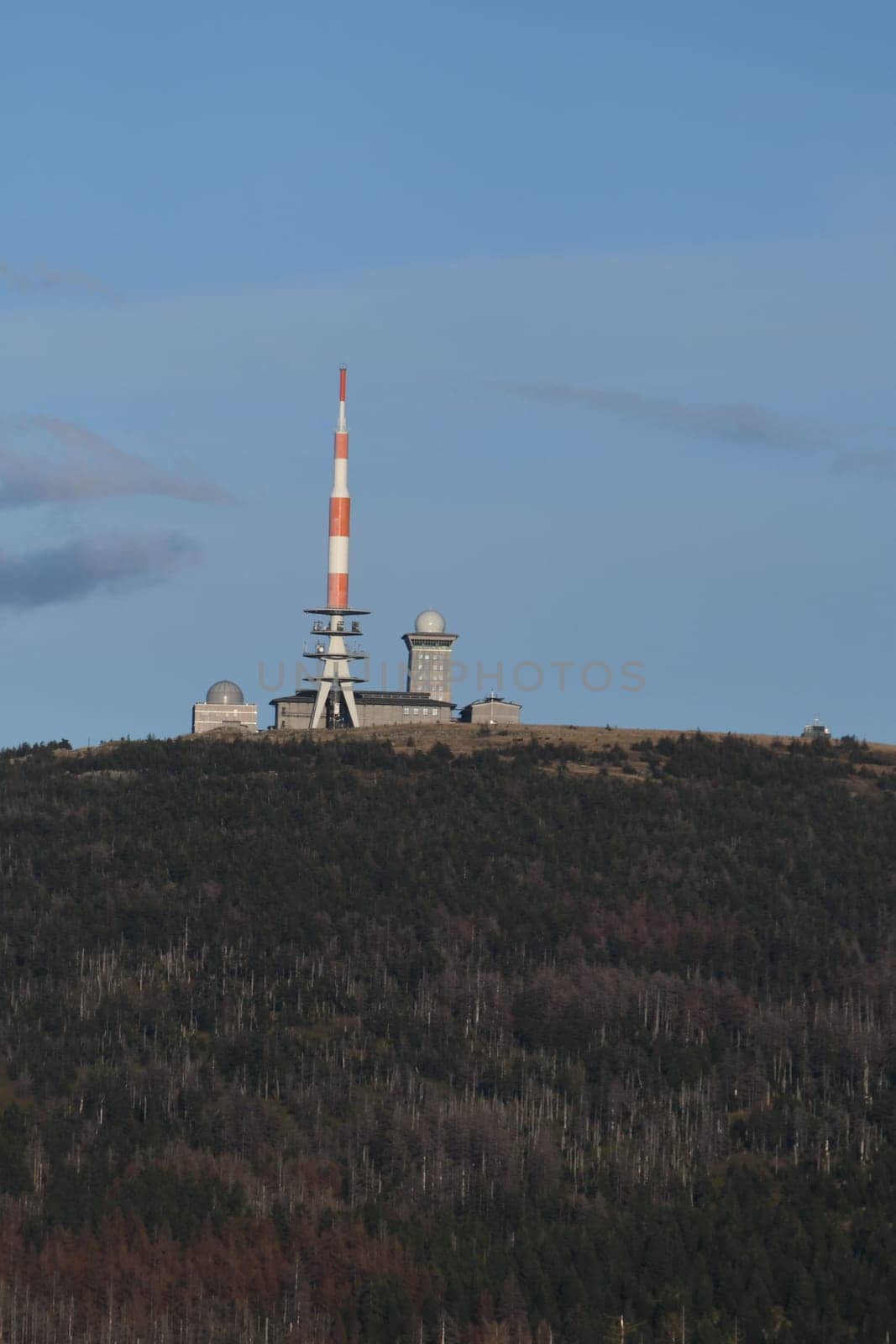 Radio tower and buildings on the Brocken mountain top under the blue sky in the Harz mountains