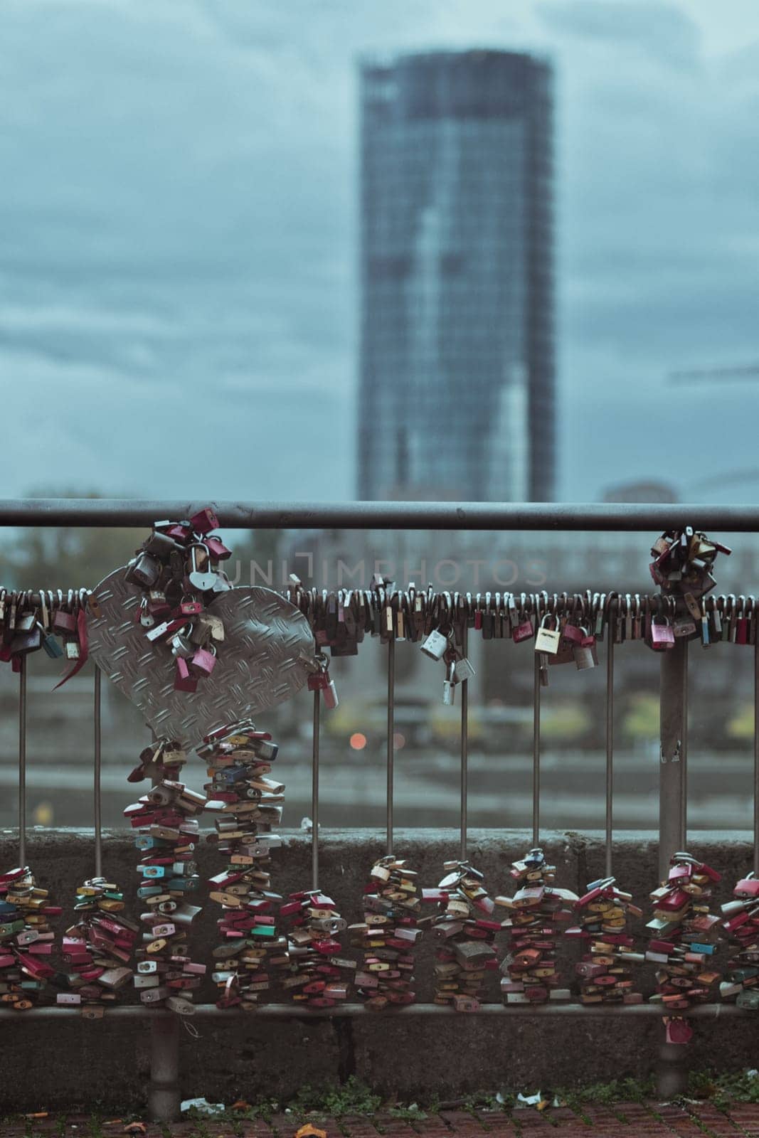 Vertical shot of many love locks on the railing of the Hohenzollern Bridge in Cologne, Germany