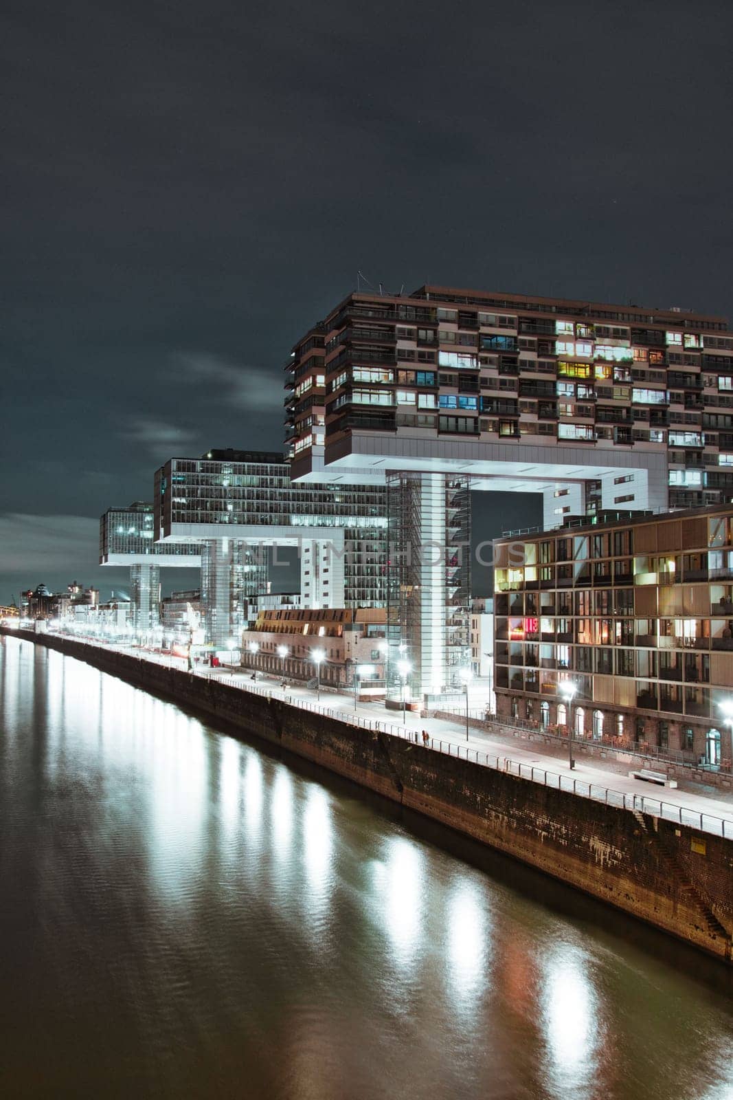 Aerial view of illuminated crane houses by the canal at the Zollhafen in Cologne, Germany at night