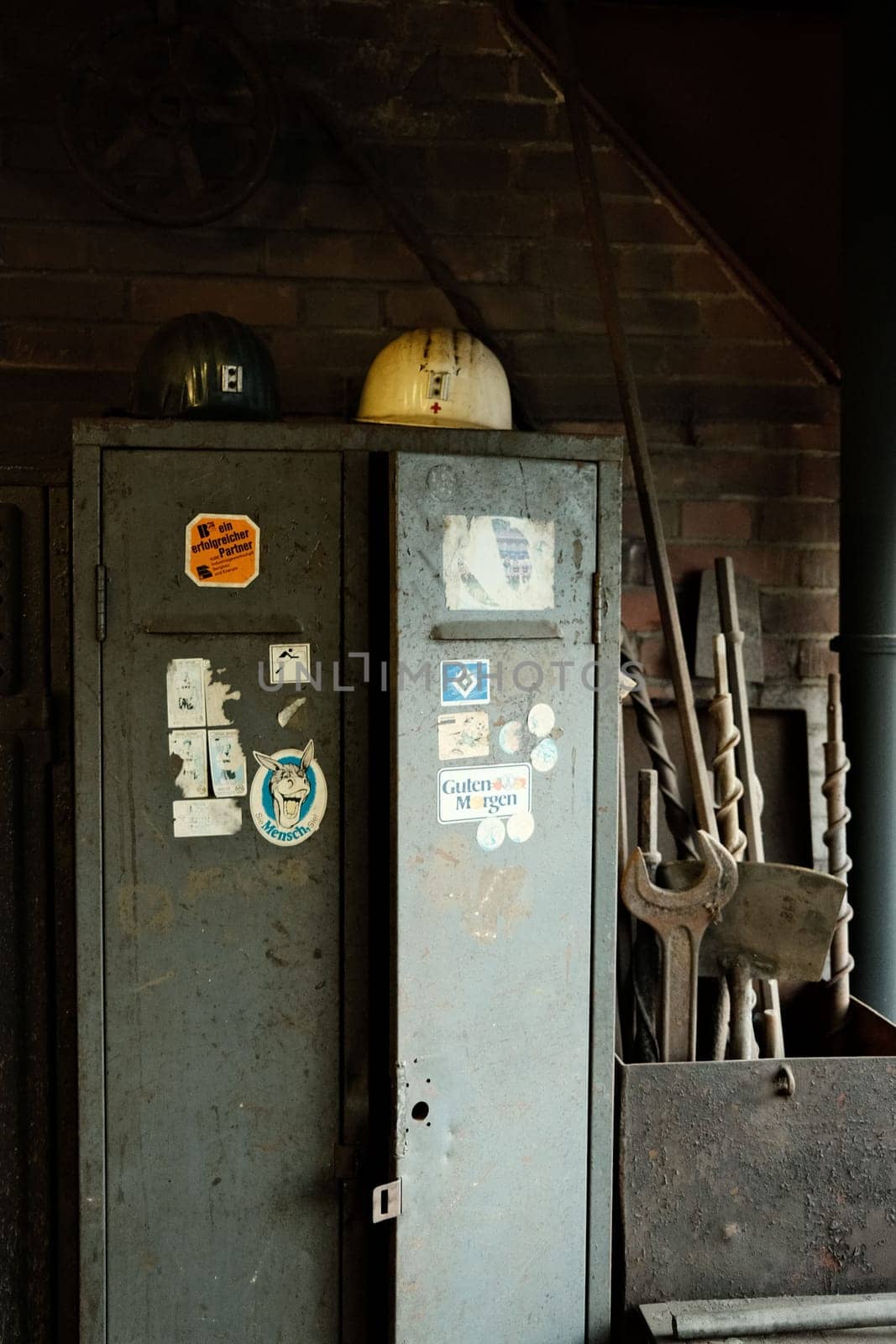 Vertical shot of the miner's helmets on an old locker in a mine in the Ruhr area, Germany