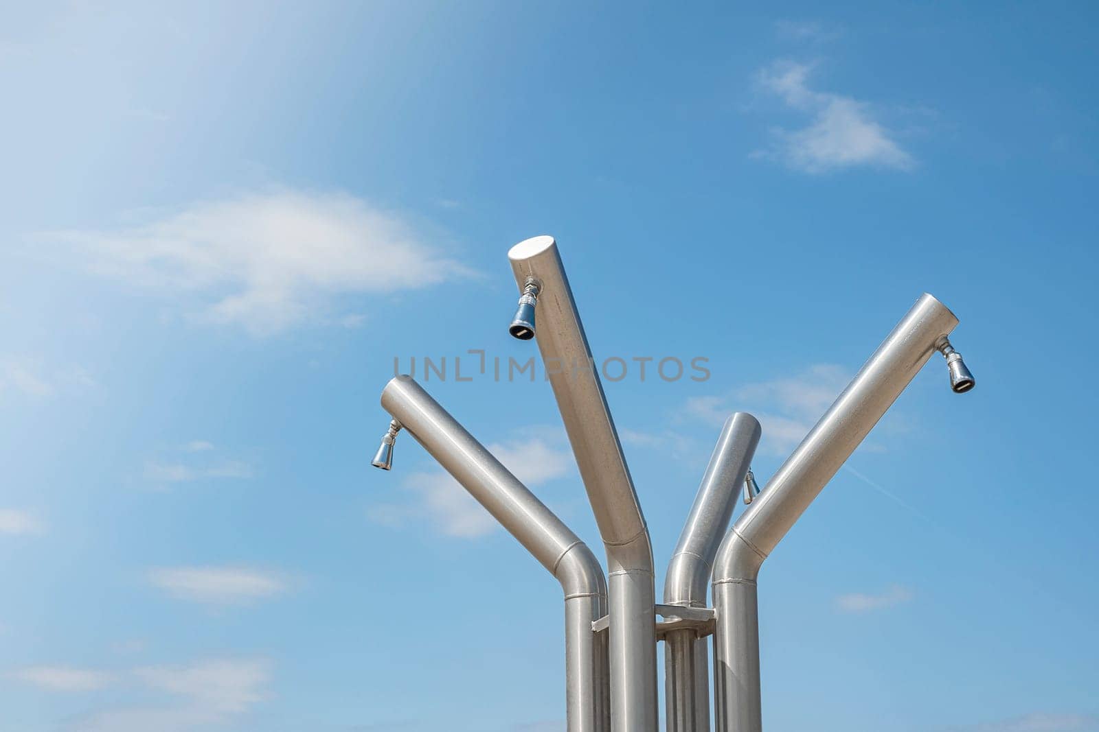 Outdoor public showers on the beach in Italy, summer holiday concept.