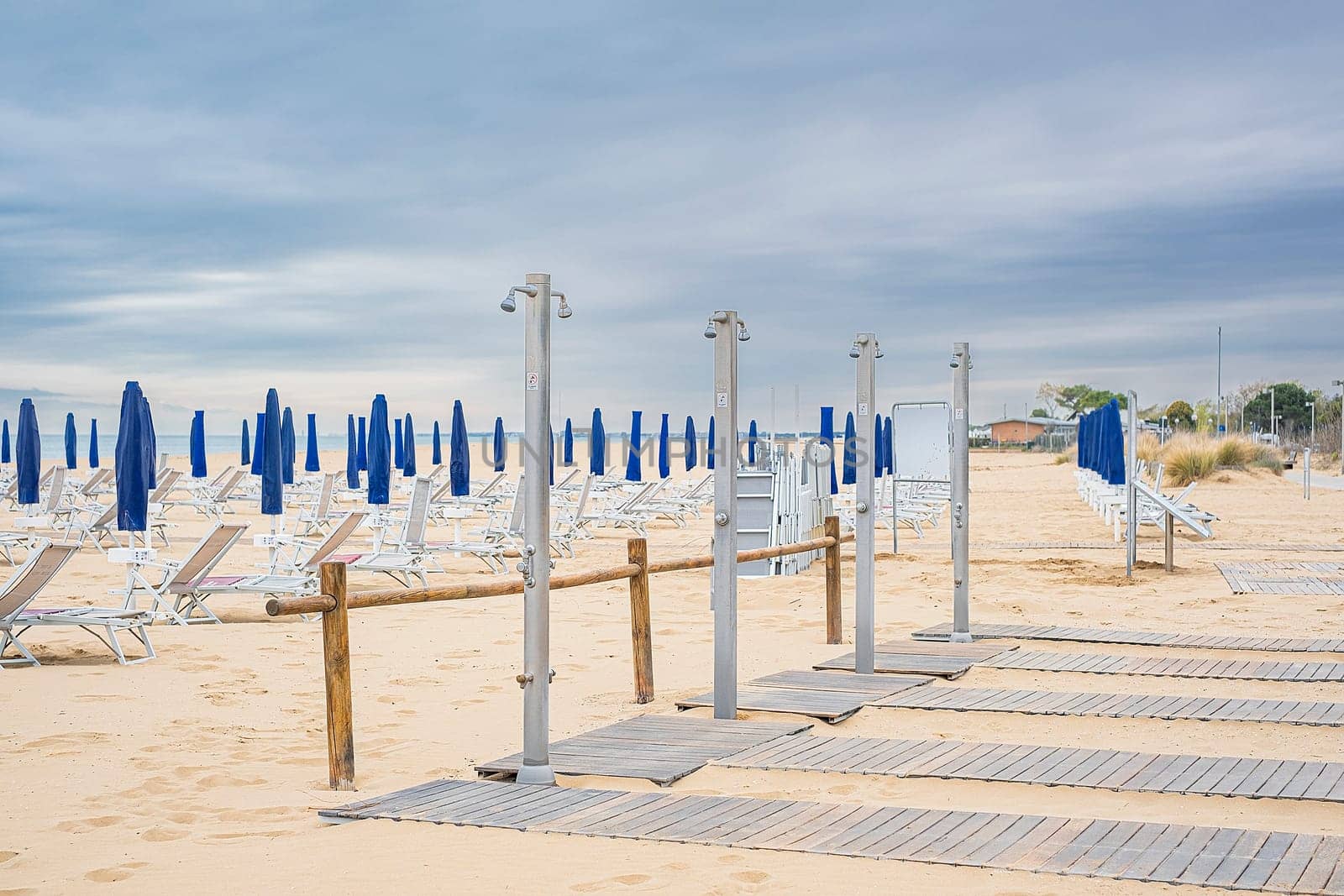 Outdoor public showers on the beach in Italy, summer holiday concept.