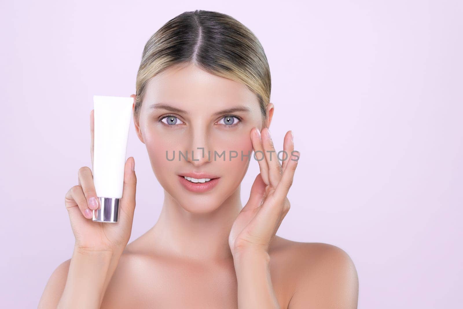 Alluring beautiful perfect cosmetic skin woman portrait hold mockup tube cream or moisturizer for skincare treatment, anti-aging product in isolated background. Natural healthy skin model concept.