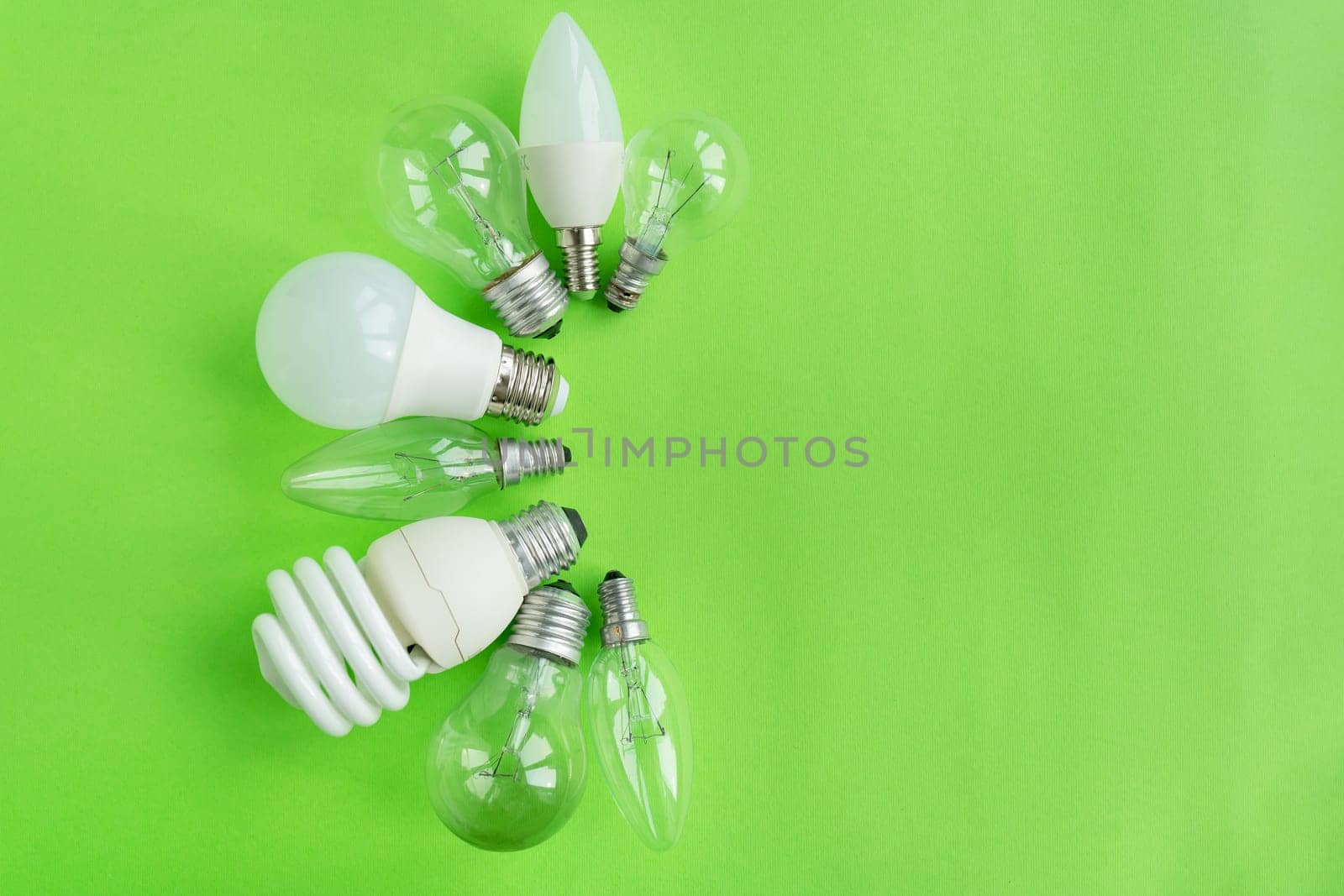 A set of different types of LED lamps isolated on a green background. Energy-saving lamps. by sfinks