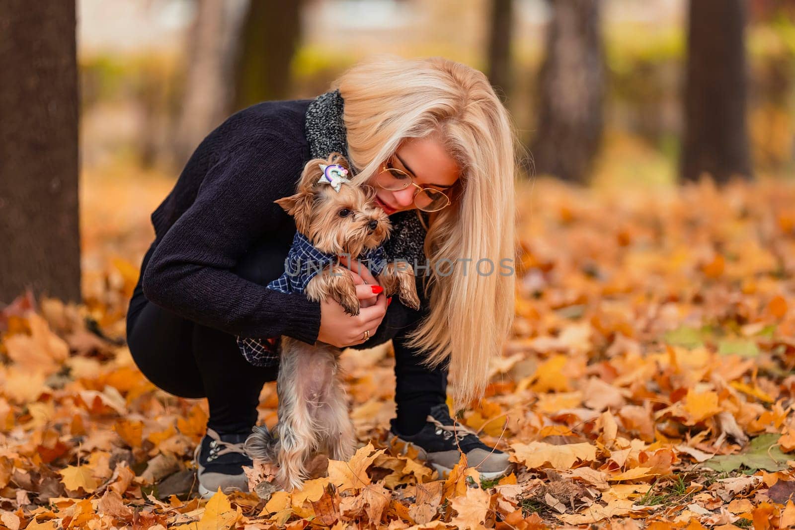 girl with her little dog in autumn park