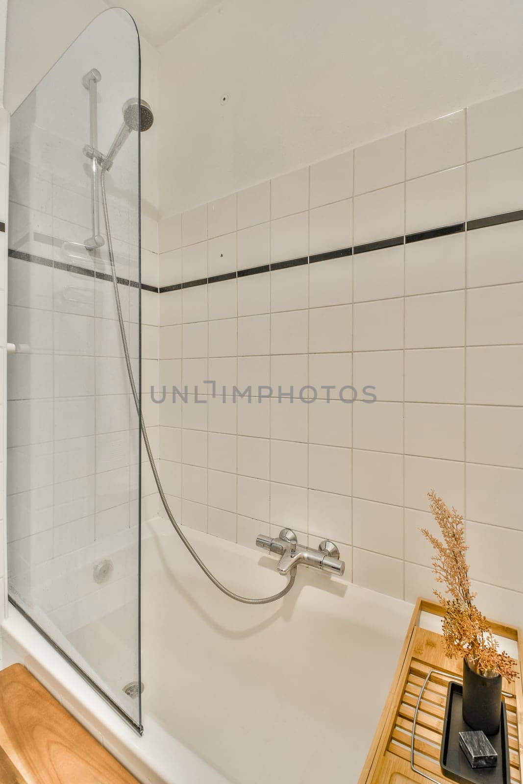 a bathroom with a bathtub and wooden stool next to the tub that's in front of the shower