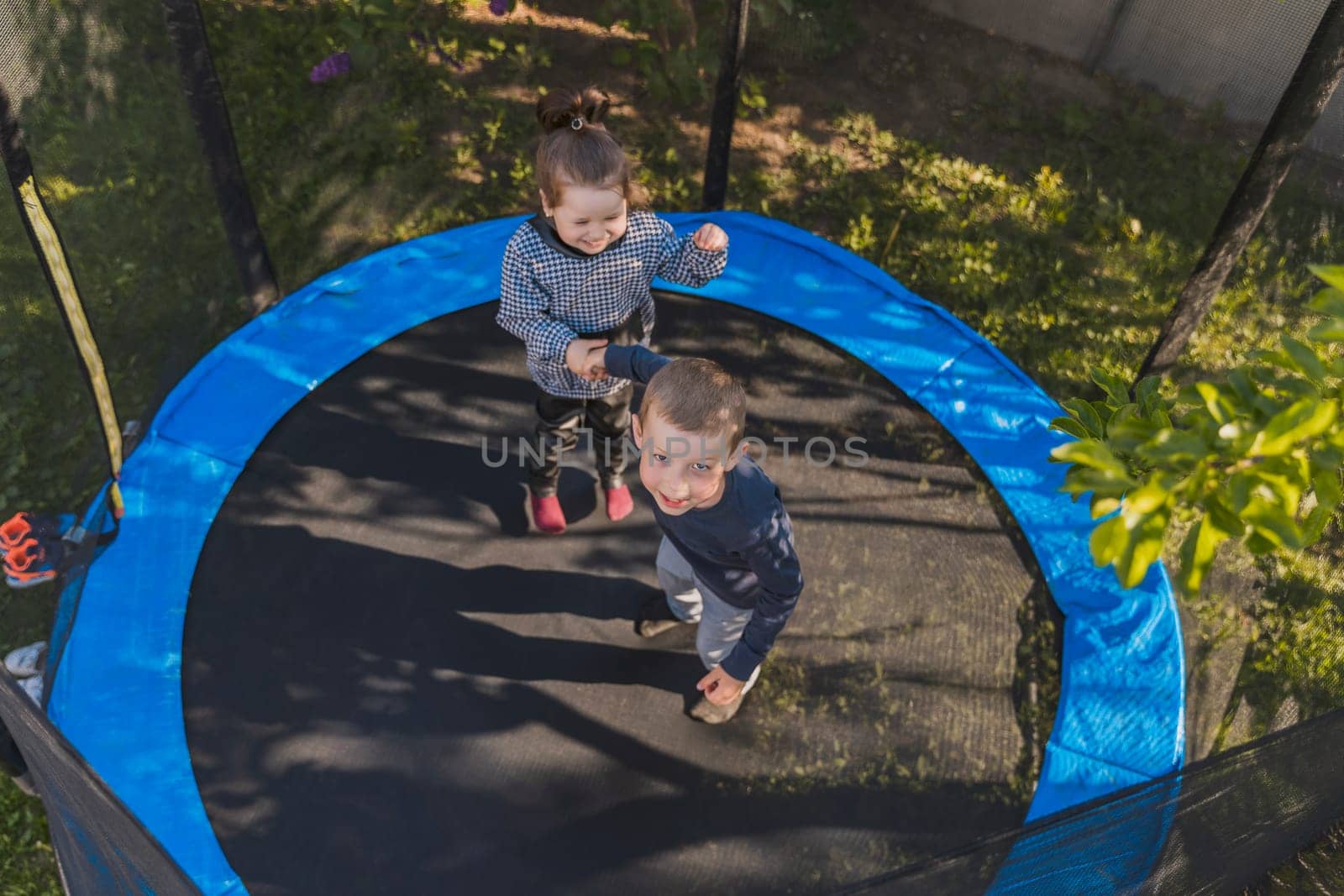 children jump on the trampoline by zokov