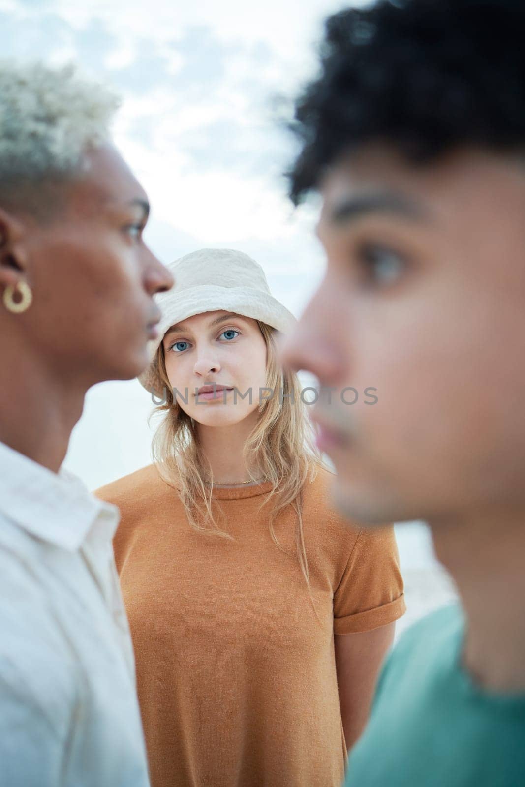 Beauty, fashion and face with a woman or model standing outdoor with her male friends in winter. Portrait, inclusion and diversity with a young female posing outside in a hat on a white background.