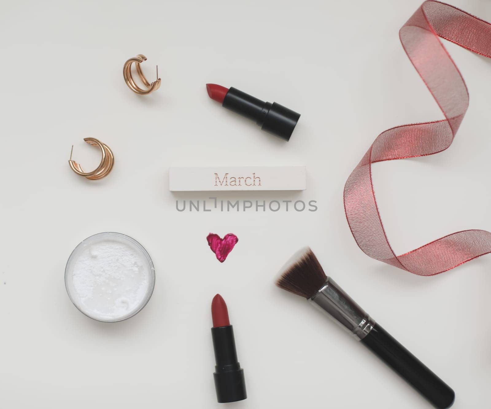 Concept Women's Day, Valentines Day, March 8. Lipstick, cosmetic makeup products and accessories flatlay top view. by paralisart