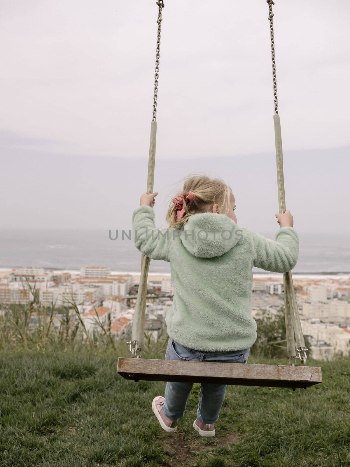 Swinging on Wooden Swing with Ocean and City View by gcm