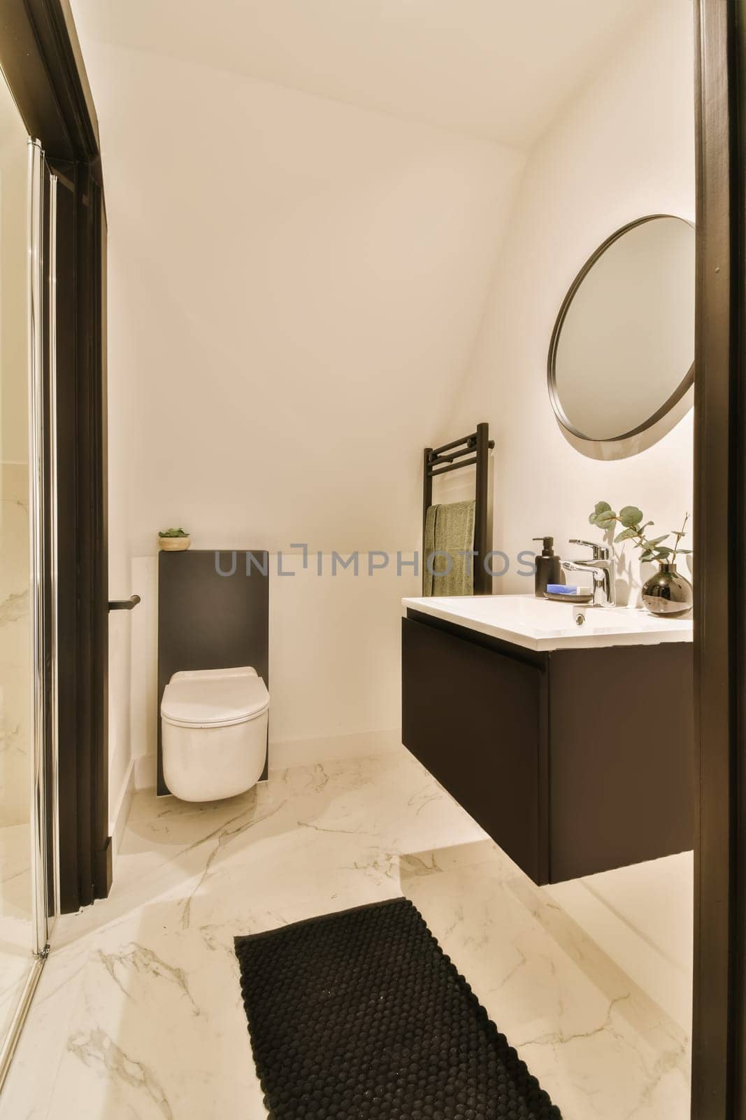 a modern bathroom with marble flooring and black door leading to the shower room, while it is white in color