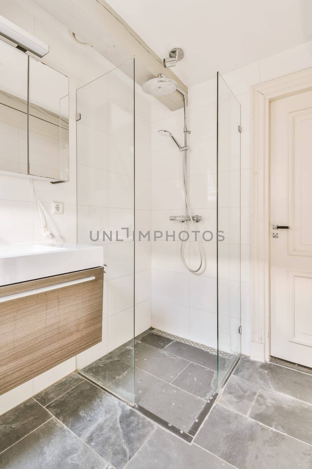 a bathroom with a sink, mirror and shower head mounted on the wall next to the bathtub that's attached to the