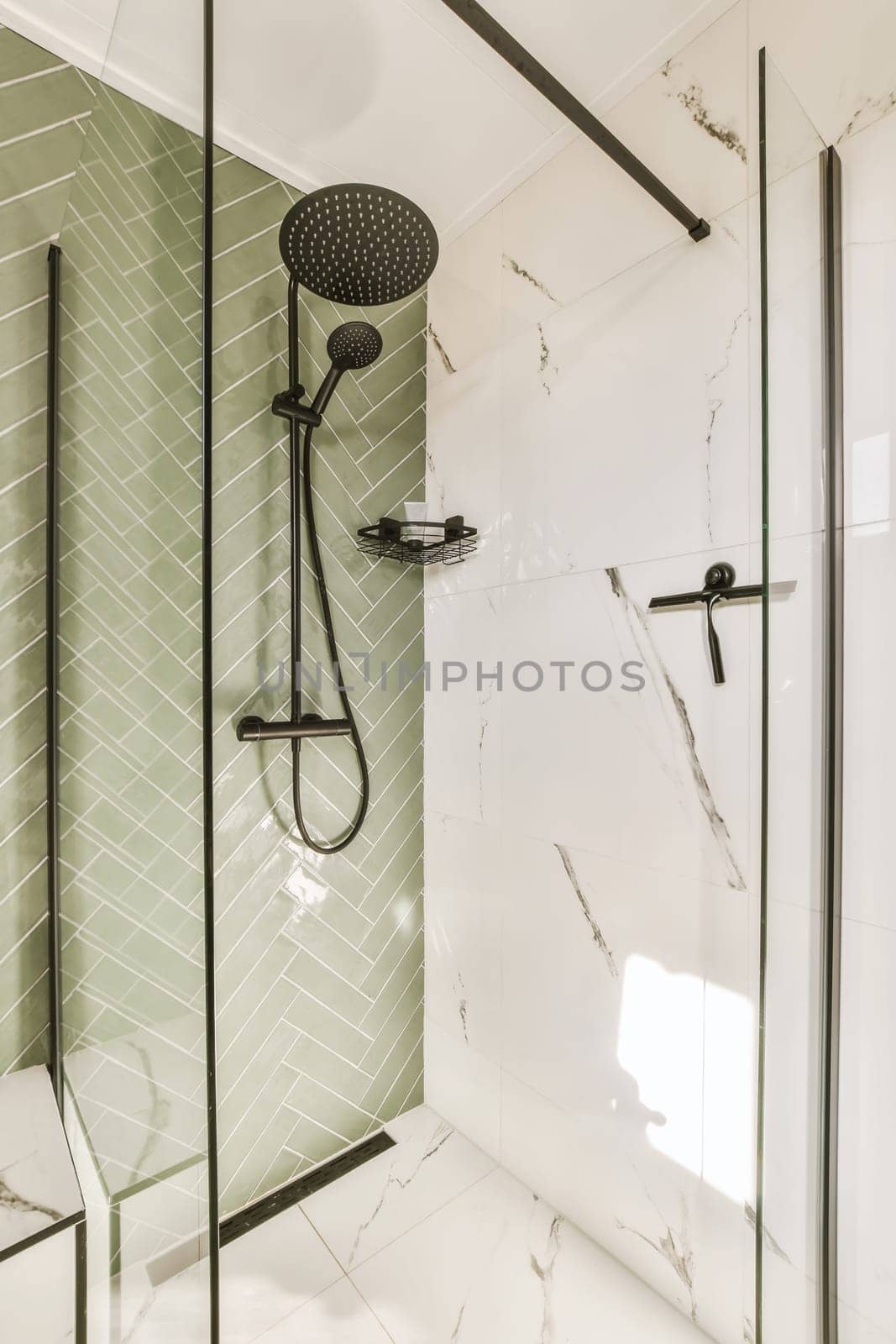 a shower with a shower head and a glass door by casamedia