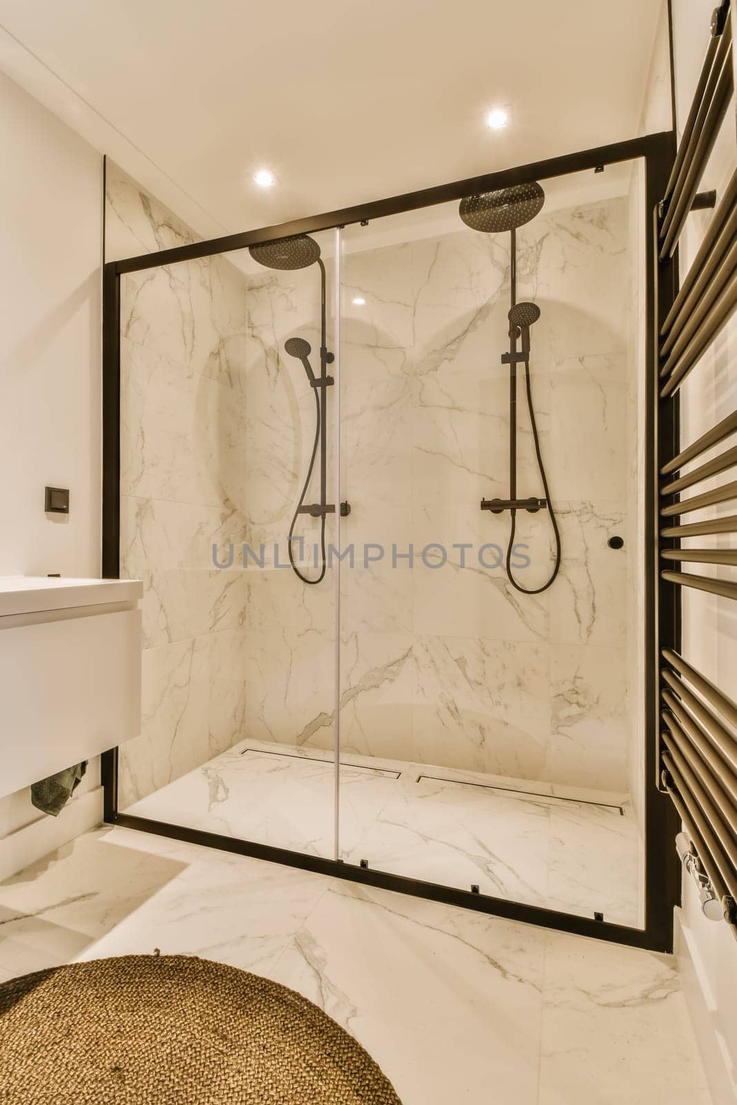 a large shower with a glass door in a bathroom by casamedia