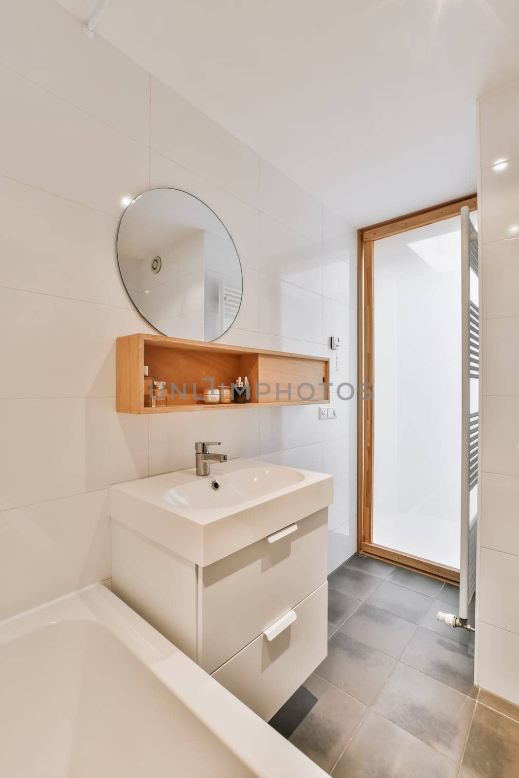 a bathroom with a sink, mirror and bathtub next to the tub in this photo is taken from above