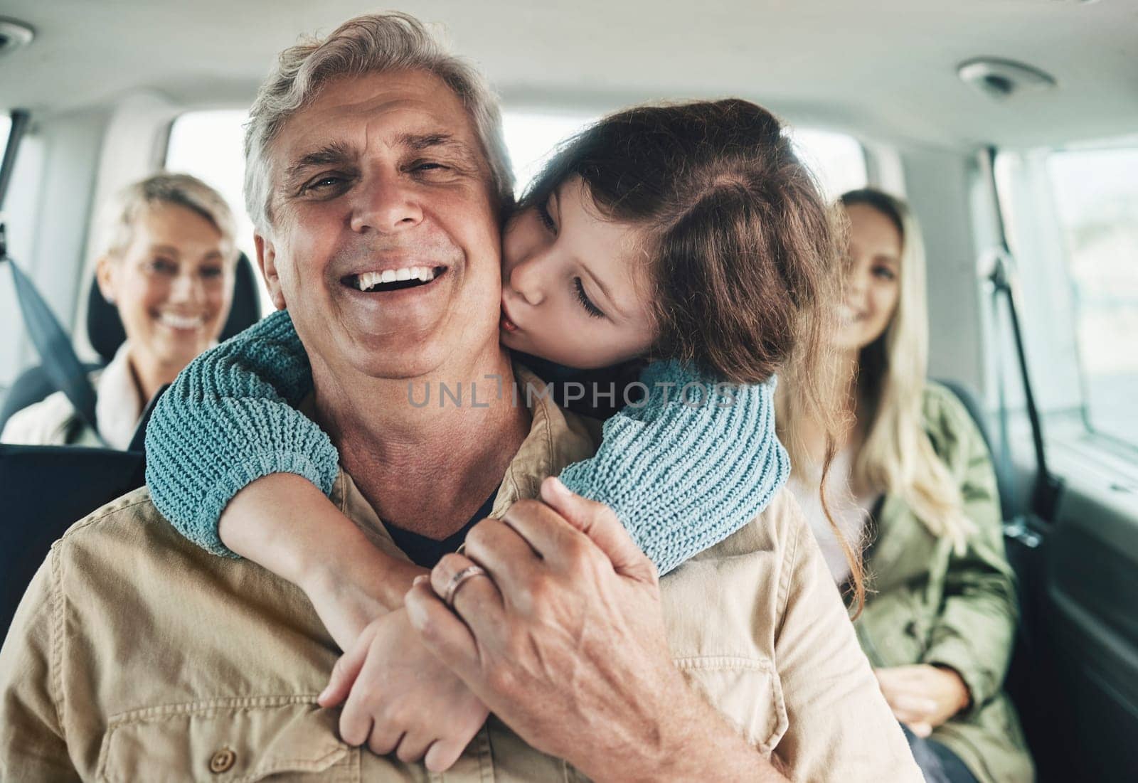 Happy, family kiss and road trip travel of children and parents traveling in a car for vacation. Happiness hug, kids and elderly people using transportation with love and care ready for a holiday.