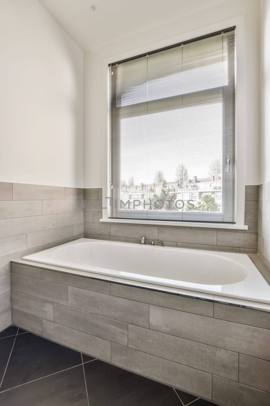 a large bath tub in a bathroom with a window by casamedia