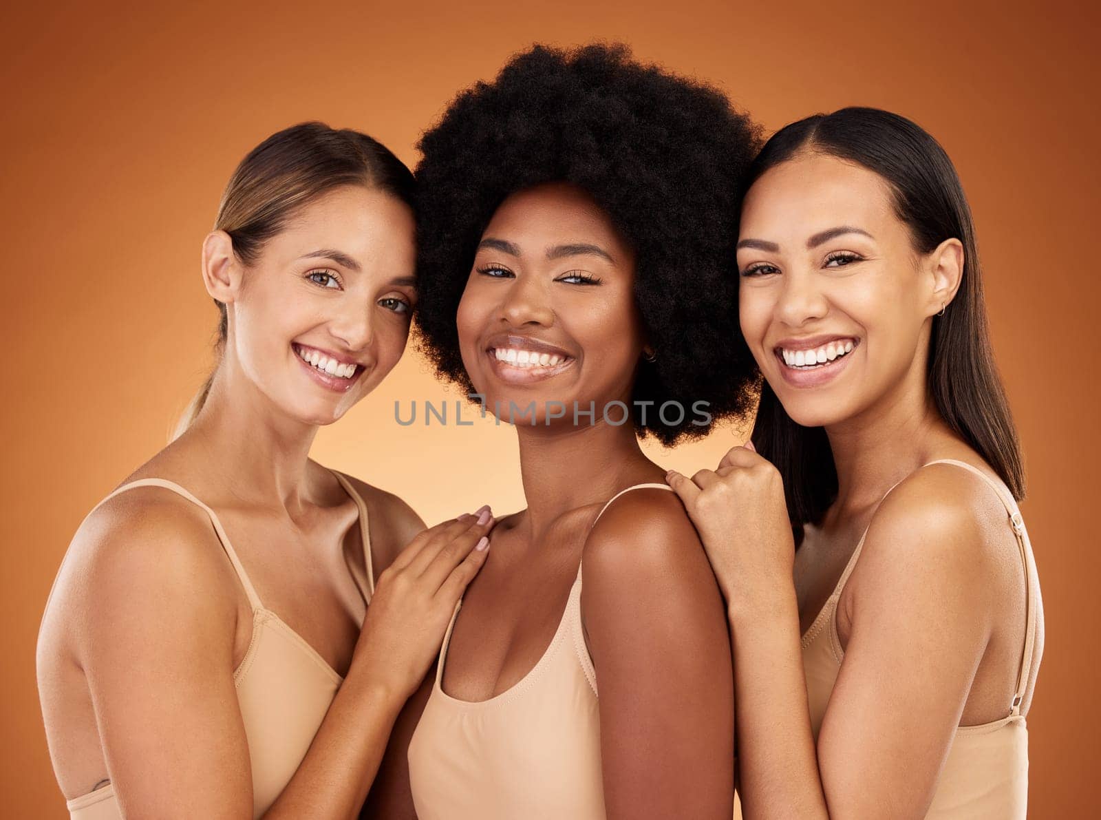 Natural, skincare and portrait of group of women to model beauty, cosmetics and makeup. Beauty products, diversity and multicultural girls with healthy skin, wellness and body care in brown studio by YuriArcurs