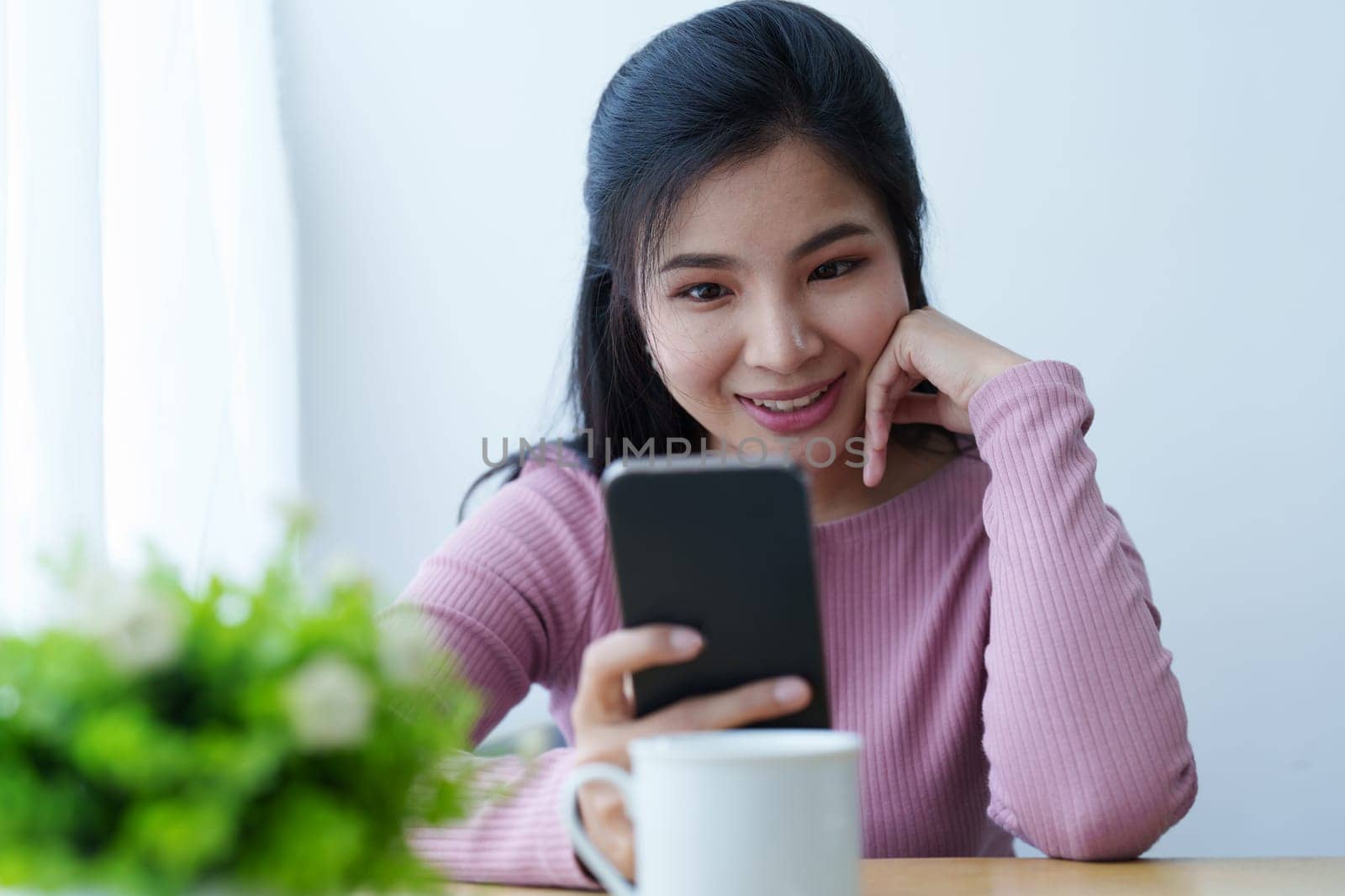 Portrait of a beautiful Asian teenage girl using a smartphone mobile.