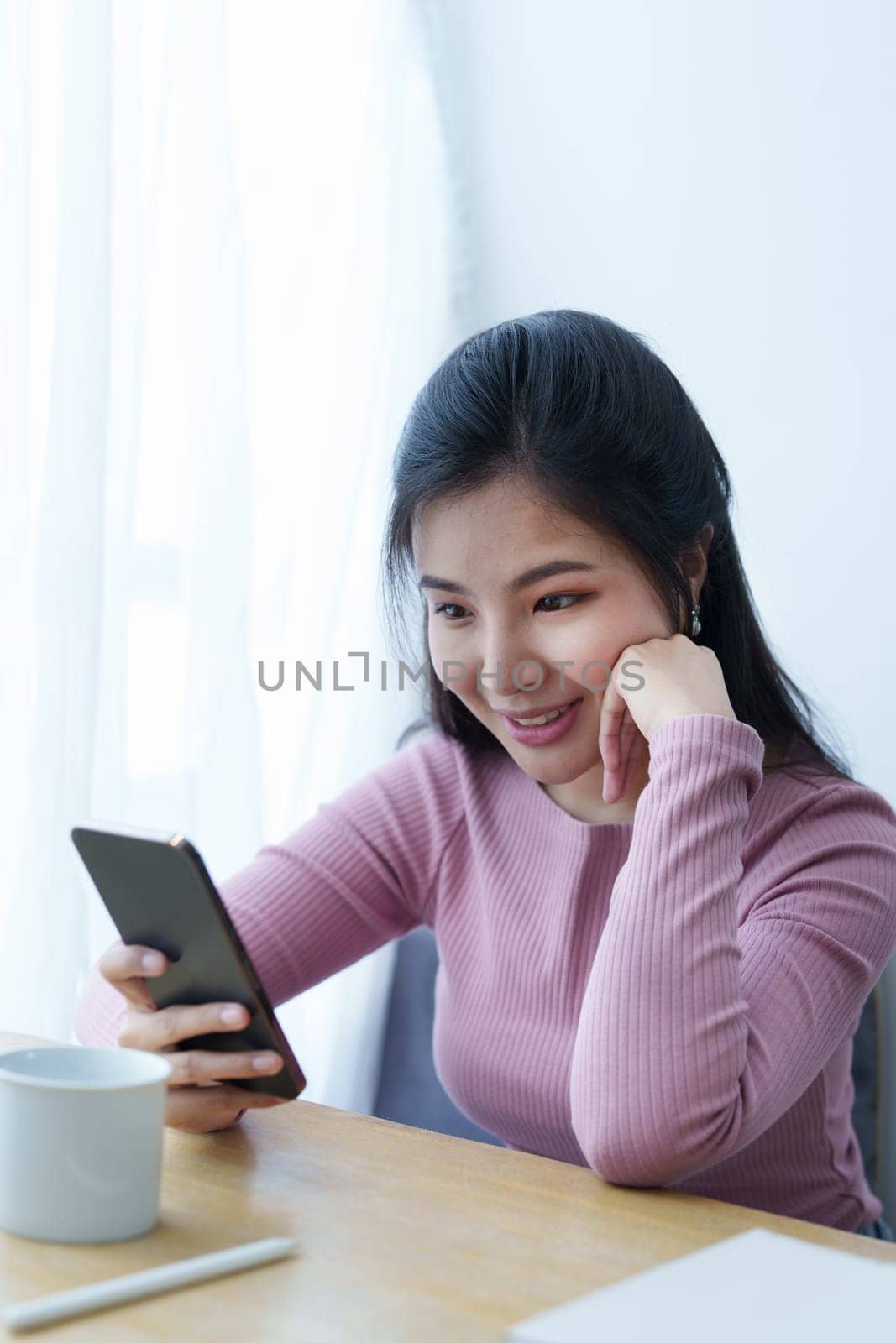 Portrait of a beautiful Asian teenage girl using a smartphone mobile.