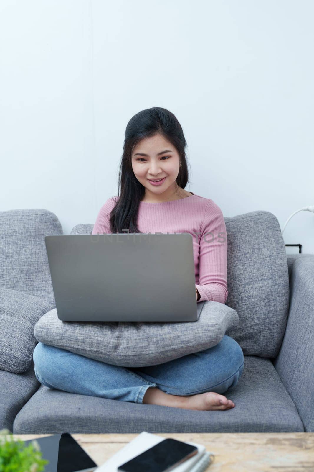 Portrait of a beautiful Asian teenage girl using a computer by Manastrong