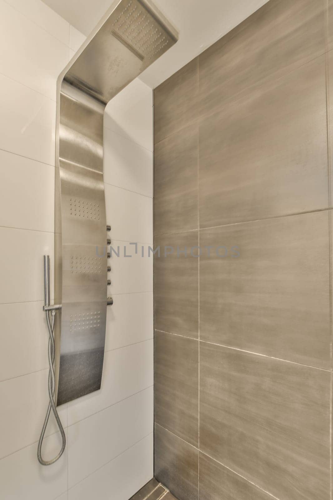 a large white shower with a stainless steel shower head by casamedia