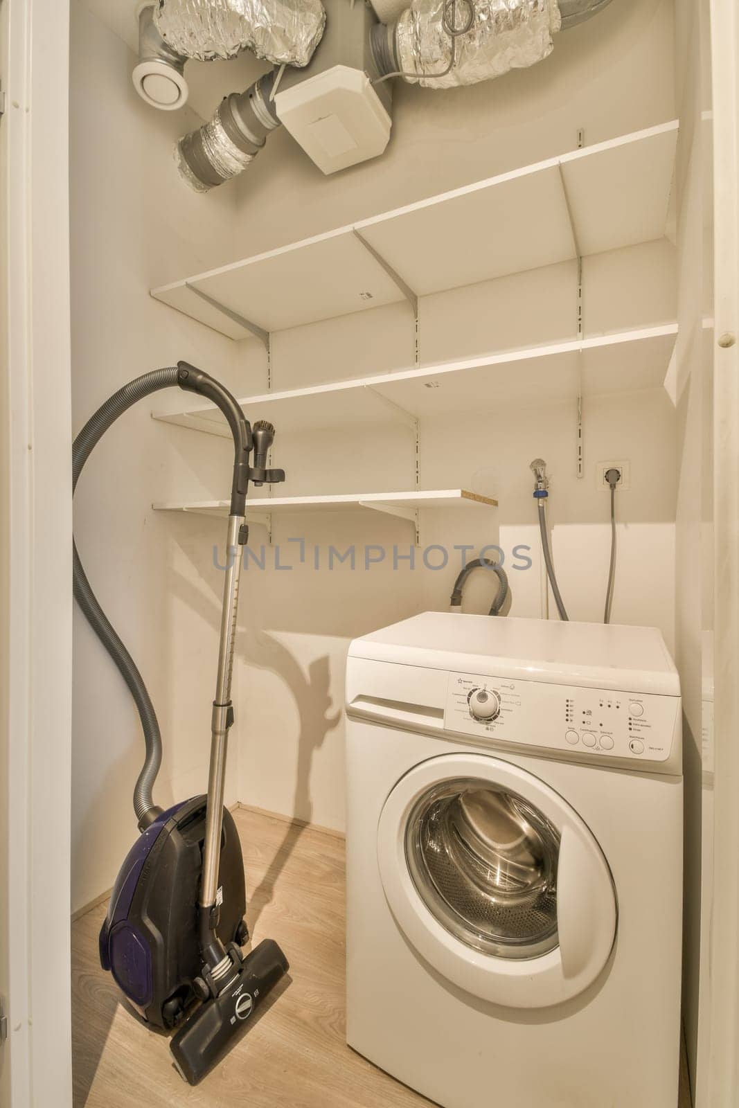 a laundry room with a washer and dryer in the corner, which has been cleaned for several years