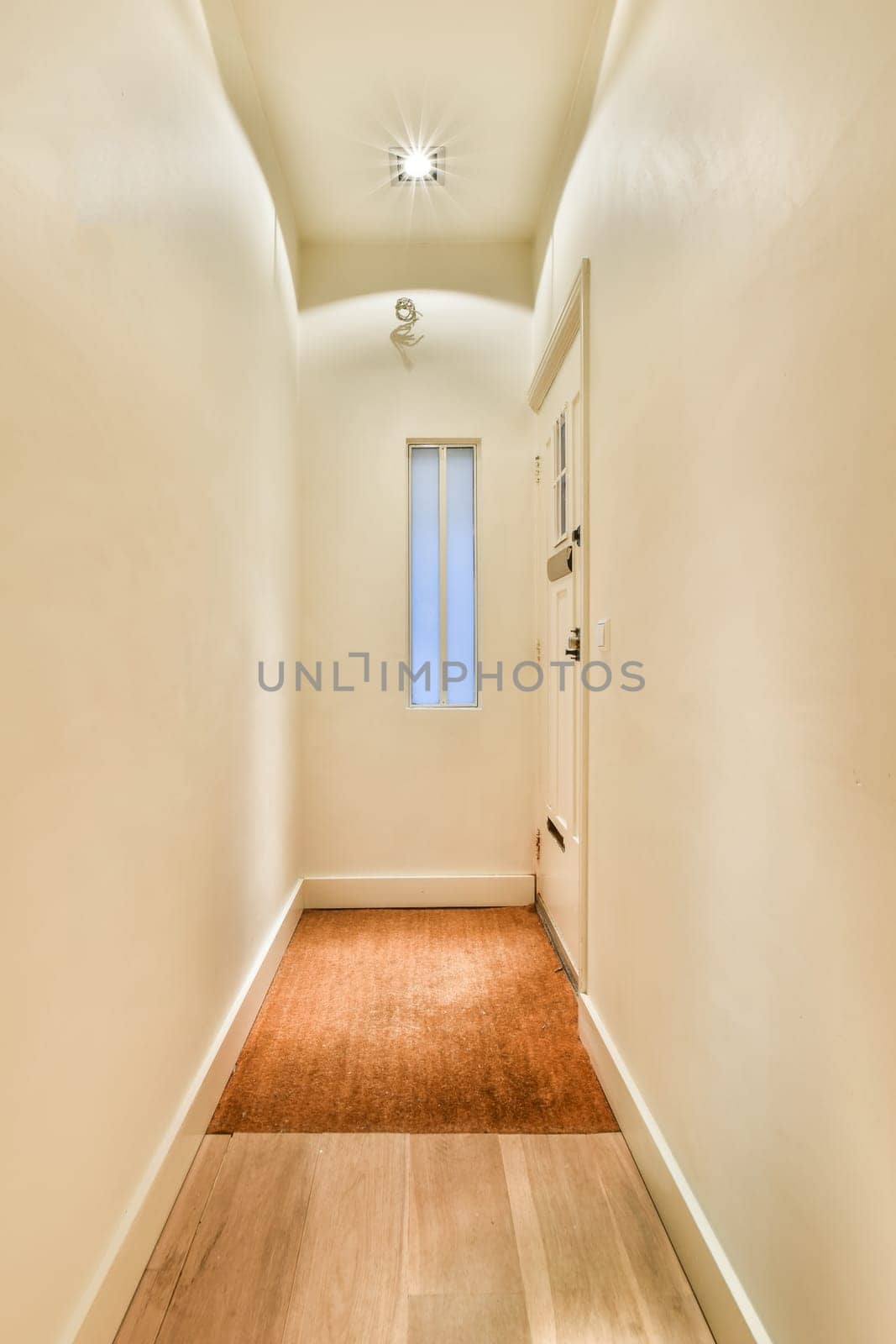 an empty room with wood floors and light fixtures on either side of the room, there is a ceiling fan