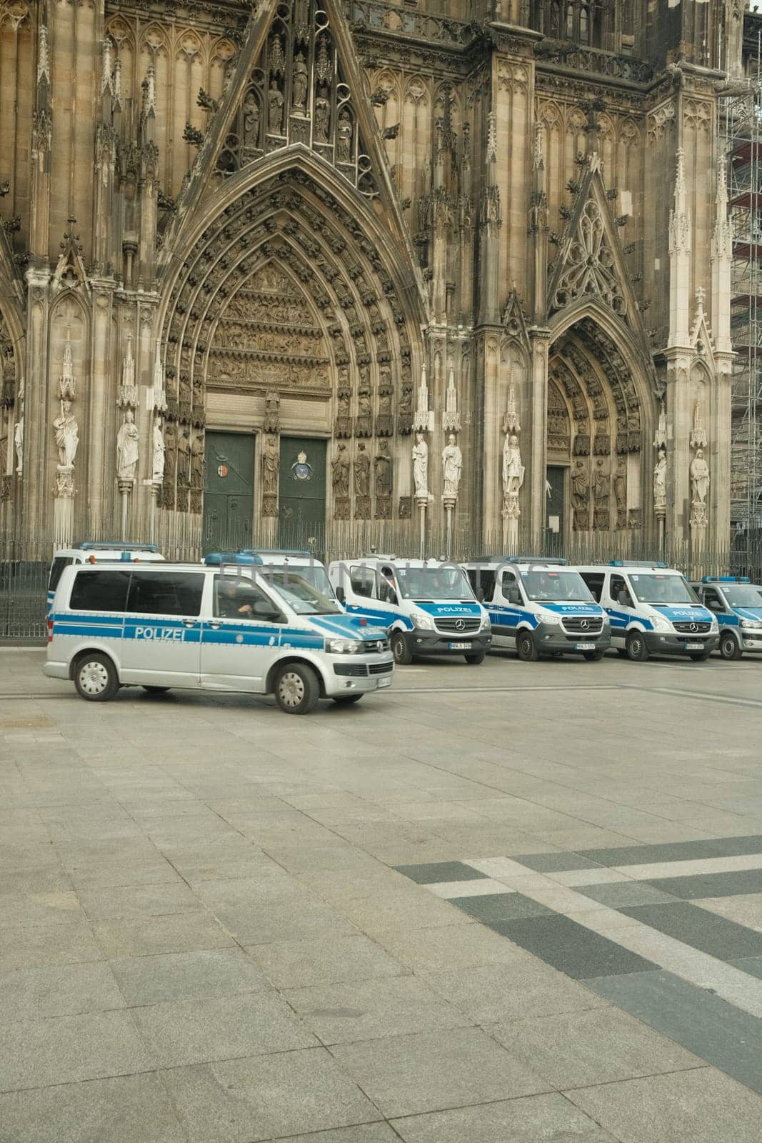 Row of Mercedes-Benz Sprinter police cars in front of Cologne Cathedral in Germany