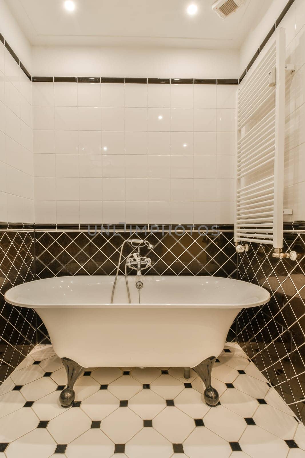 a bathroom with black and white tiles on the walls, floor, and bathtub in it's corner