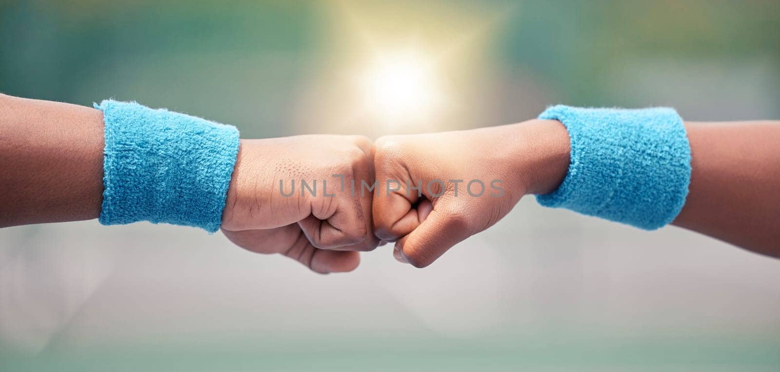 Tennis, closeup and fist bump for success, motivation and teamwork with blurred background while outdoor. Tennis player, hands and touch for respect, team building and support at training in summer by YuriArcurs