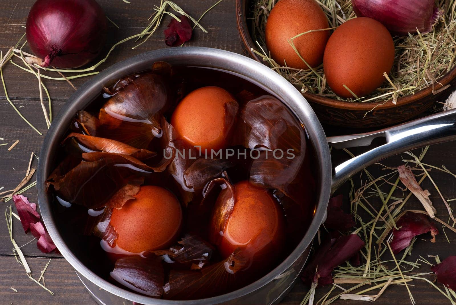Coloring chicken eggs for Easter with onion peel. Easter, Sunday. Healthy food. Dark key, rustic. Selective focus.
