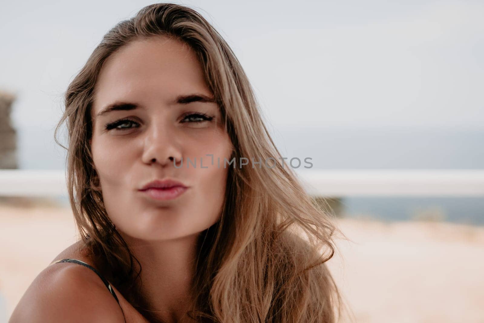 Happy woman portrait in cafe. Boho chic fashion style. Outdoor photo of young happy woman with long hair, sunny weather outdoors sitting in modern cafe